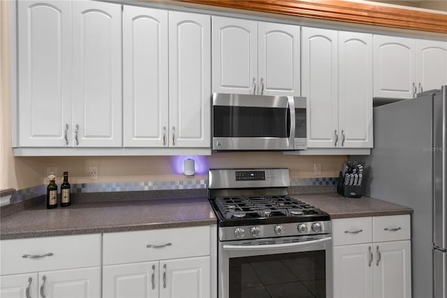 kitchen with appliances with stainless steel finishes and white cabinetry