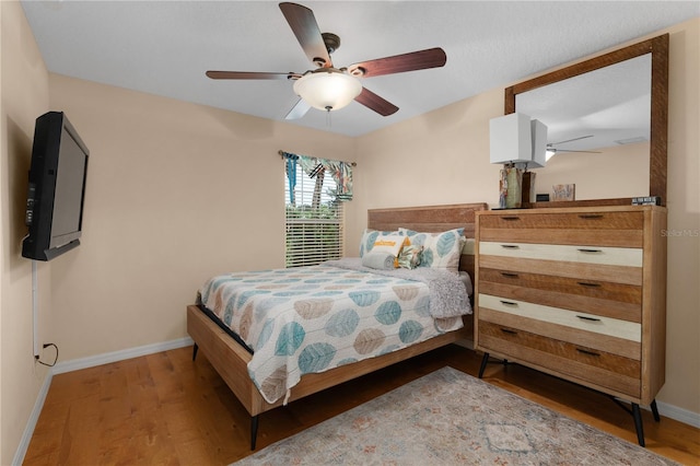 bedroom featuring ceiling fan and hardwood / wood-style flooring