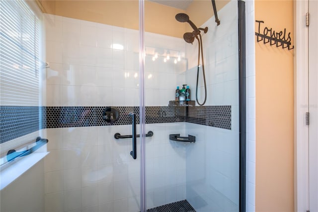 bathroom featuring a shower with shower door