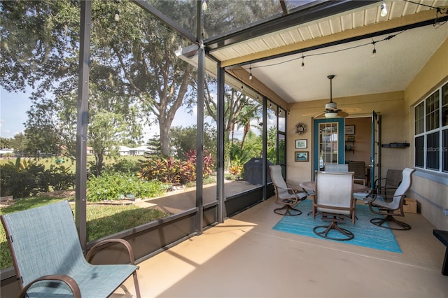 sunroom featuring ceiling fan