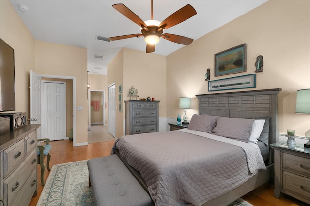 bedroom with light hardwood / wood-style floors and ceiling fan