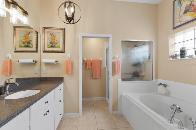 bathroom with independent shower and bath, vanity, and tile patterned flooring