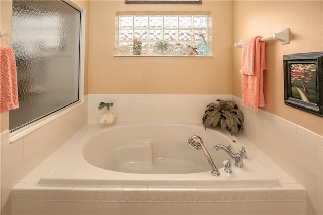 bathroom featuring tiled bath