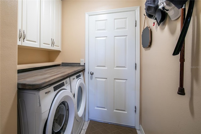 laundry area with washer and clothes dryer and cabinets