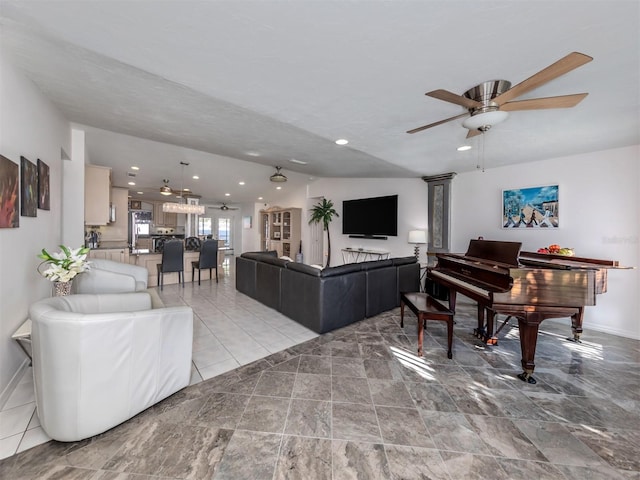 living room featuring ceiling fan and lofted ceiling