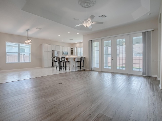 unfurnished living room featuring light hardwood / wood-style flooring and a healthy amount of sunlight