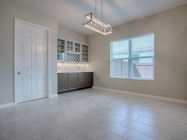 interior space featuring an inviting chandelier and light tile patterned floors