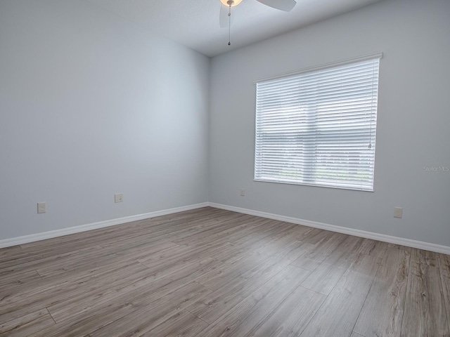 unfurnished room featuring light hardwood / wood-style floors and ceiling fan