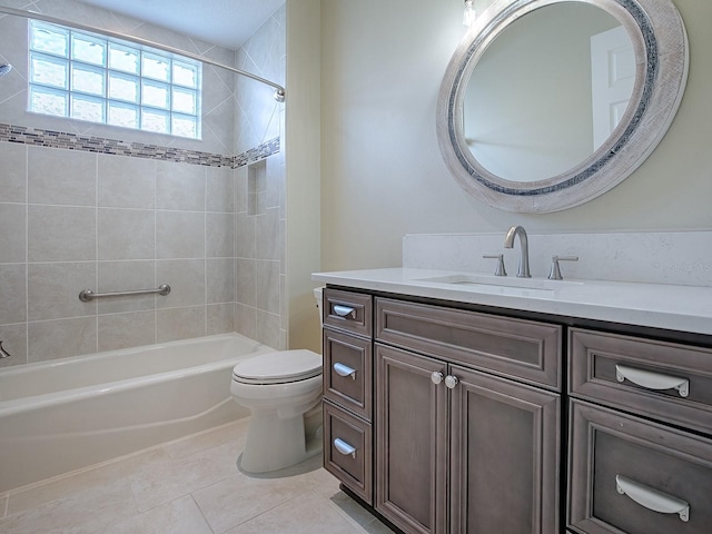 full bathroom featuring tiled shower / bath combo, vanity, toilet, and tile patterned floors