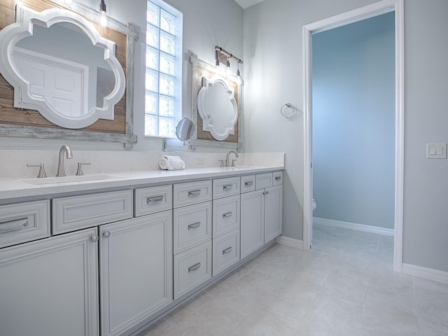 bathroom featuring vanity, tile patterned floors, toilet, and a healthy amount of sunlight