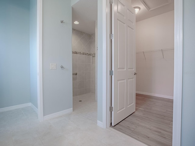 bathroom featuring tile patterned floors and tiled shower