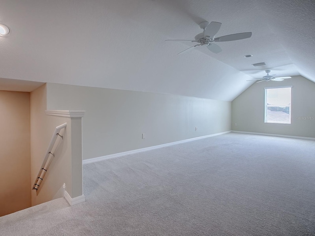 additional living space featuring ceiling fan, a textured ceiling, lofted ceiling, and light carpet