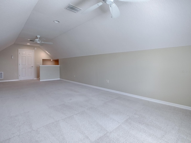 additional living space featuring ceiling fan, lofted ceiling, and light carpet