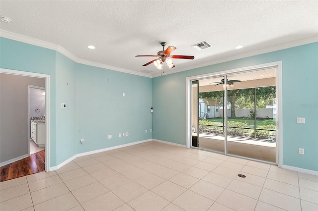 unfurnished room featuring light tile patterned floors, a textured ceiling, and ornamental molding