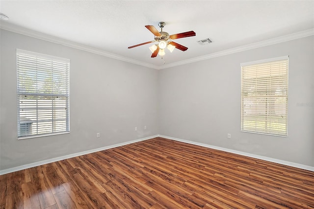 spare room with hardwood / wood-style floors, a healthy amount of sunlight, and ornamental molding