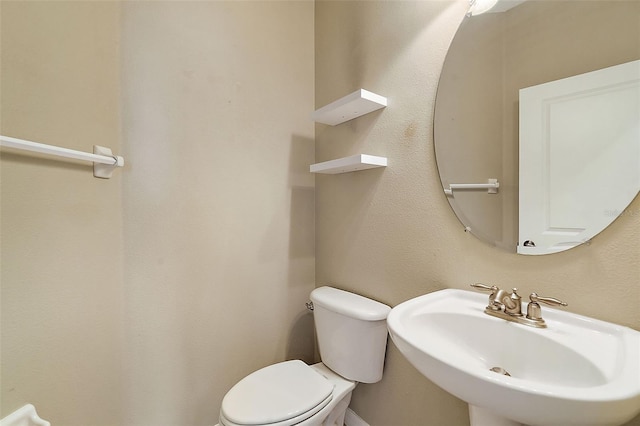 bathroom featuring toilet and sink