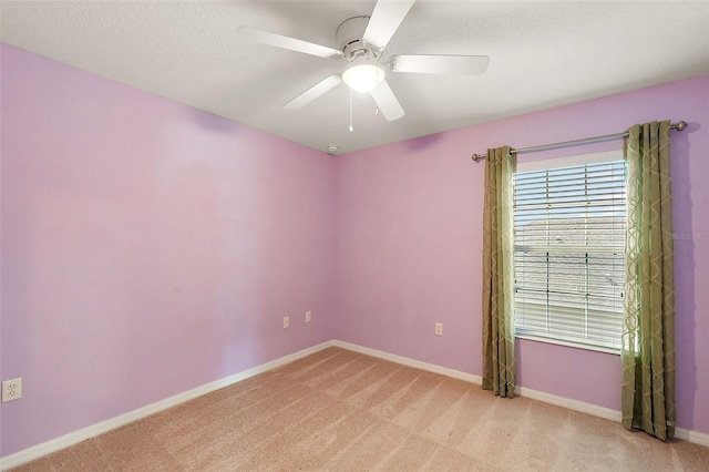 carpeted spare room with ceiling fan and a textured ceiling