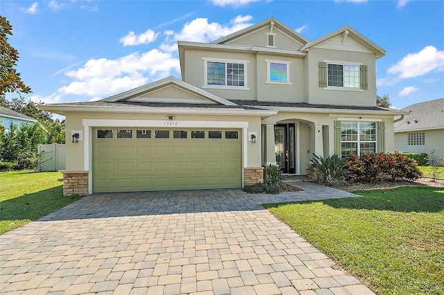 view of front facade with a garage and a front yard