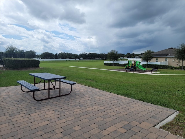 surrounding community featuring a playground and a yard