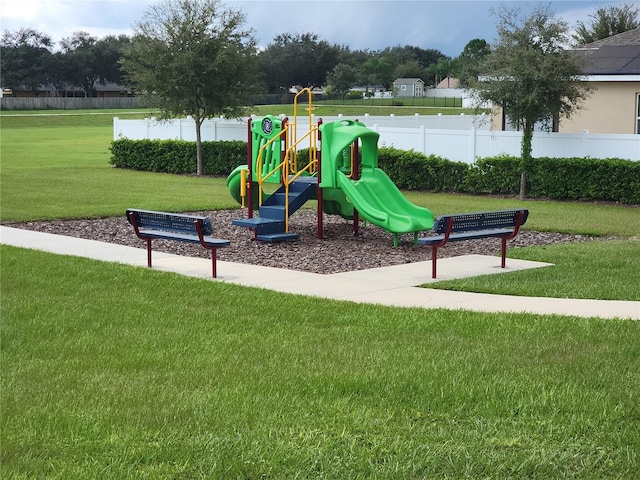 view of playground with a lawn