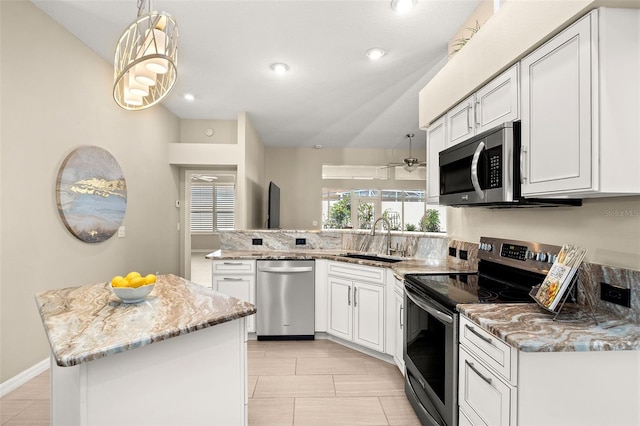 kitchen featuring sink, appliances with stainless steel finishes, white cabinetry, a center island, and decorative light fixtures