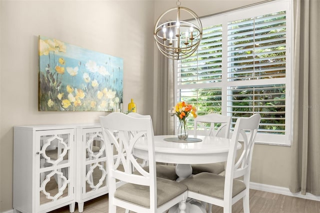 dining area featuring a notable chandelier, hardwood / wood-style floors, and a wealth of natural light