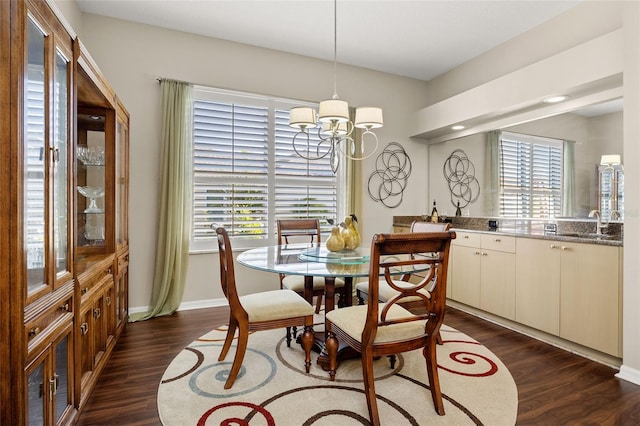 dining area with plenty of natural light, a chandelier, and dark hardwood / wood-style flooring