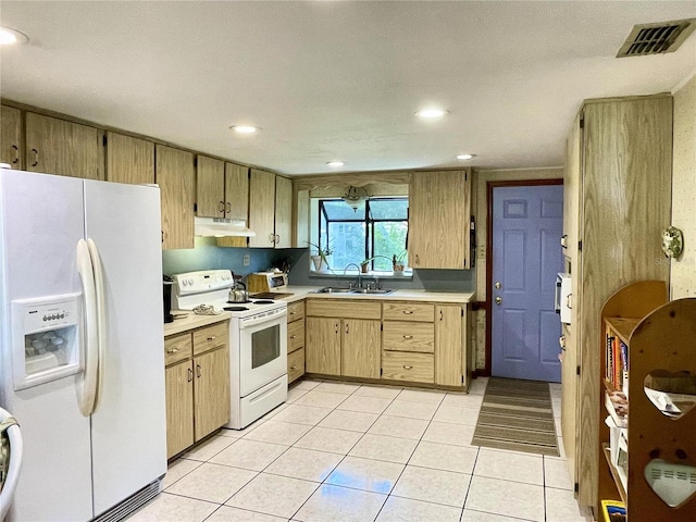 kitchen featuring light tile patterned floors, light brown cabinets, sink, and white appliances