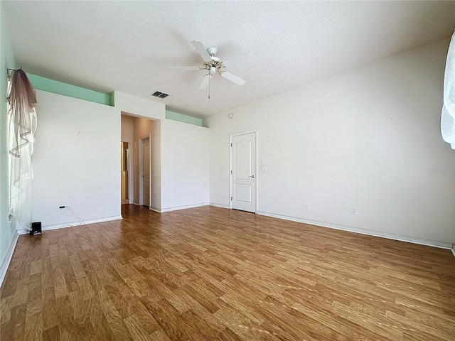 unfurnished room with hardwood / wood-style floors and ceiling fan