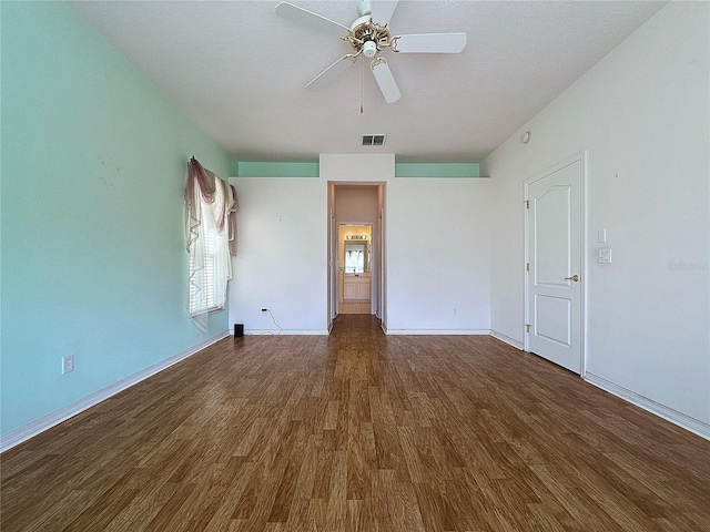 unfurnished room with dark wood-type flooring, ceiling fan, and a textured ceiling