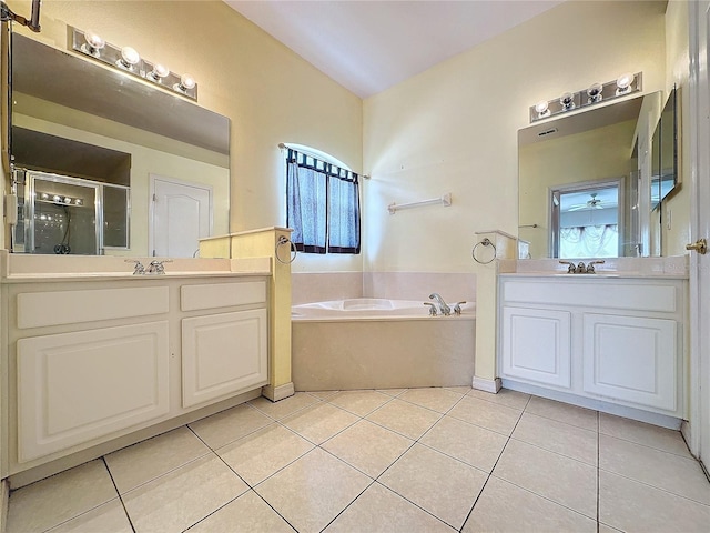 bathroom with vanity, tile patterned flooring, and plus walk in shower