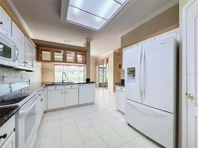 kitchen featuring white cabinetry, sink, ornamental molding, light tile patterned floors, and white appliances