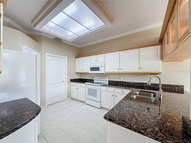 kitchen featuring sink, ornamental molding, dark stone countertops, white appliances, and white cabinets