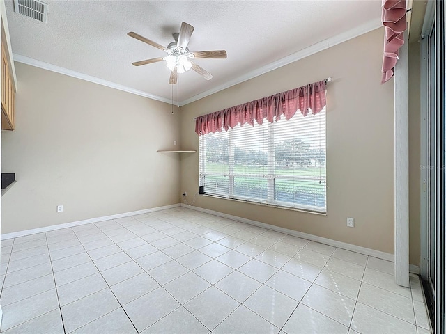 tiled empty room featuring ceiling fan, a textured ceiling, and crown molding