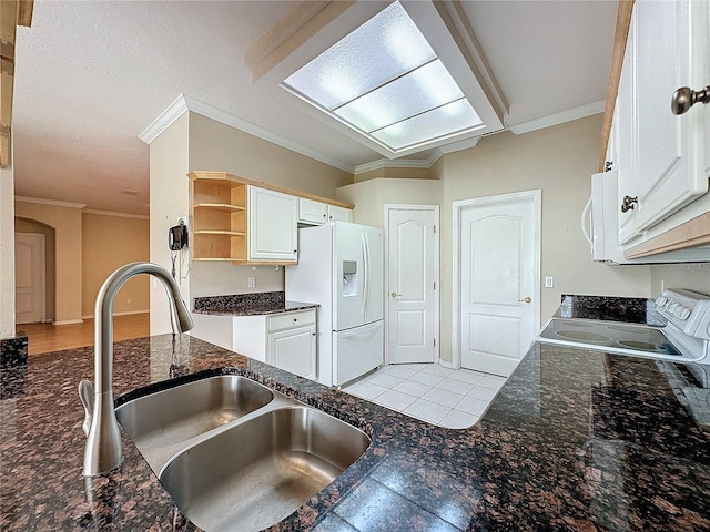 kitchen featuring ornamental molding, white cabinetry, sink, and white appliances