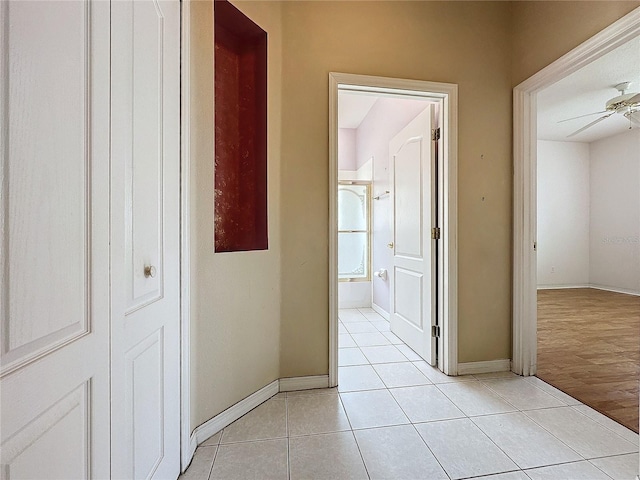 hallway with light hardwood / wood-style floors