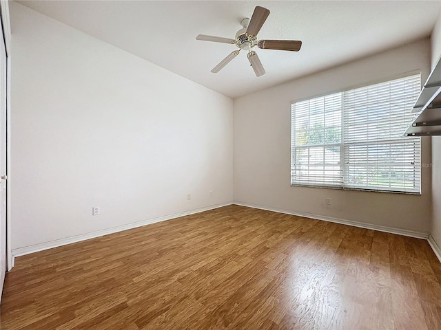 unfurnished room with hardwood / wood-style flooring and ceiling fan