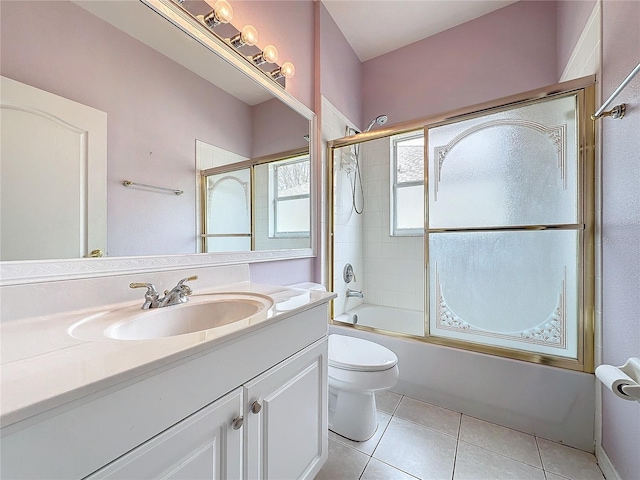 full bathroom with tile patterned flooring, vanity, toilet, and bath / shower combo with glass door