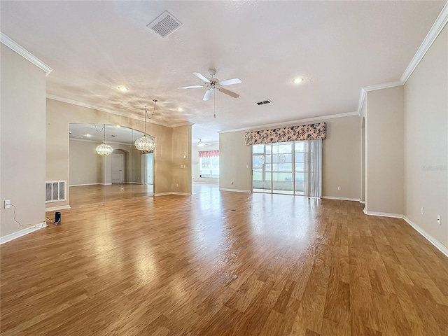 interior space featuring hardwood / wood-style floors, ceiling fan with notable chandelier, and crown molding