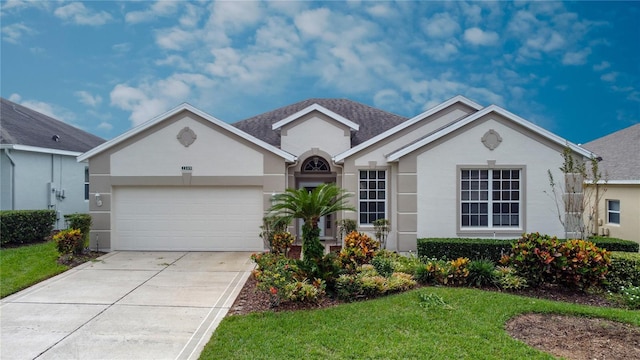 ranch-style house with a garage and a front yard