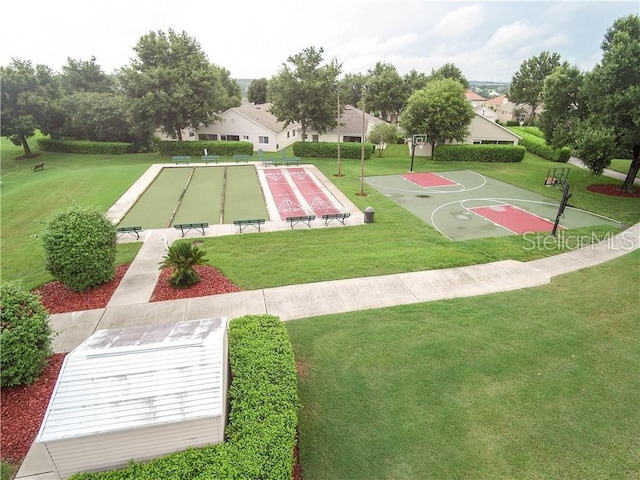 view of basketball court featuring a yard