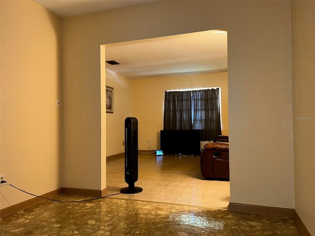 hallway featuring a textured ceiling