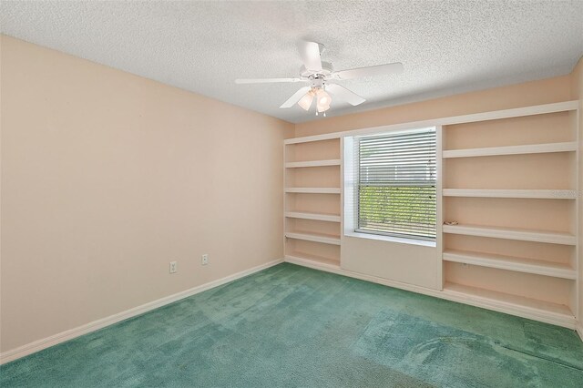 carpeted spare room featuring ceiling fan and a textured ceiling