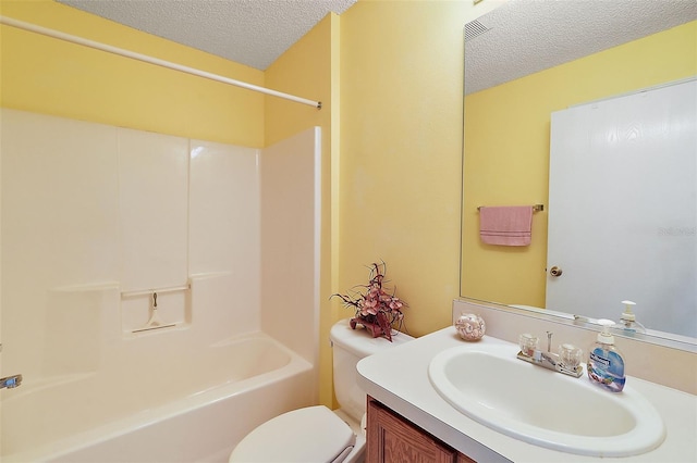 full bathroom with tub / shower combination, a textured ceiling, vanity, and toilet