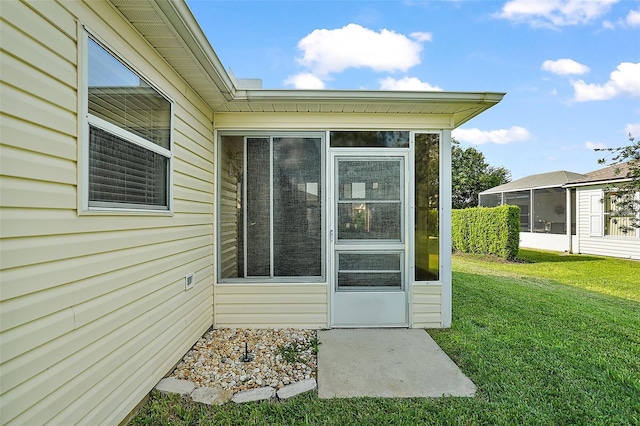 doorway to property featuring a yard