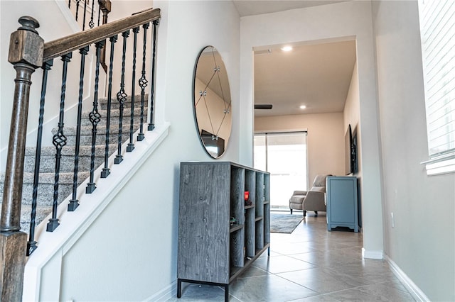 stairs featuring tile patterned floors and a healthy amount of sunlight