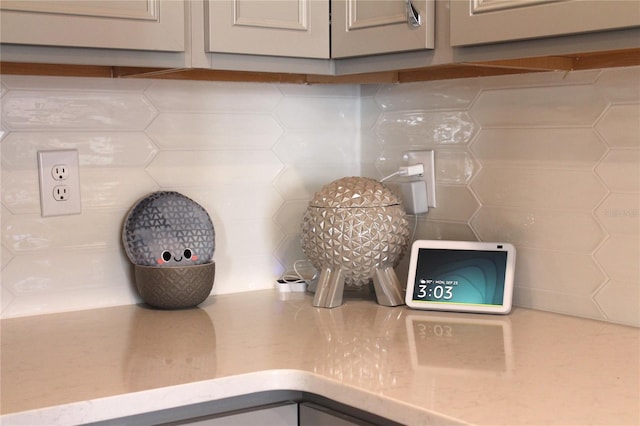 details featuring gray cabinets and tasteful backsplash