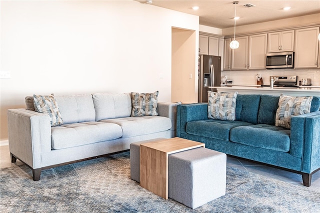 living room featuring sink and dark tile patterned floors