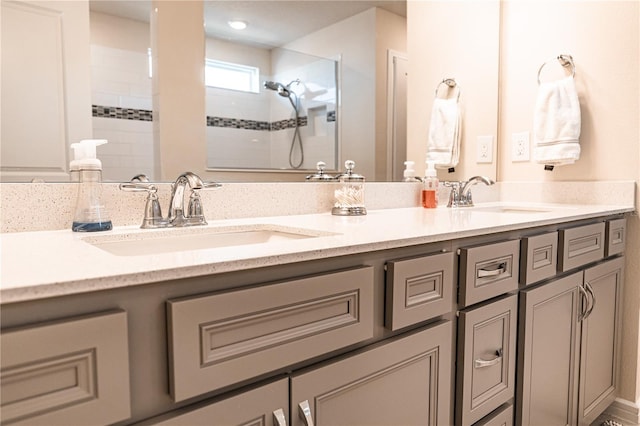 bathroom featuring tiled shower and vanity