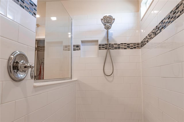 bathroom with tiled shower